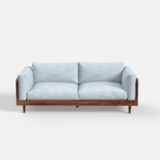 Light blue sofa with wooden frame on a white background