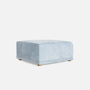 Blue textured ottoman on a white background